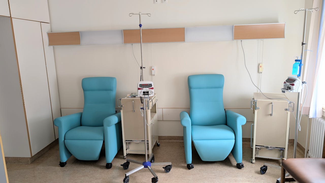 Calm hospital room featuring infusion chairs and equipment for chemotherapy treatment.